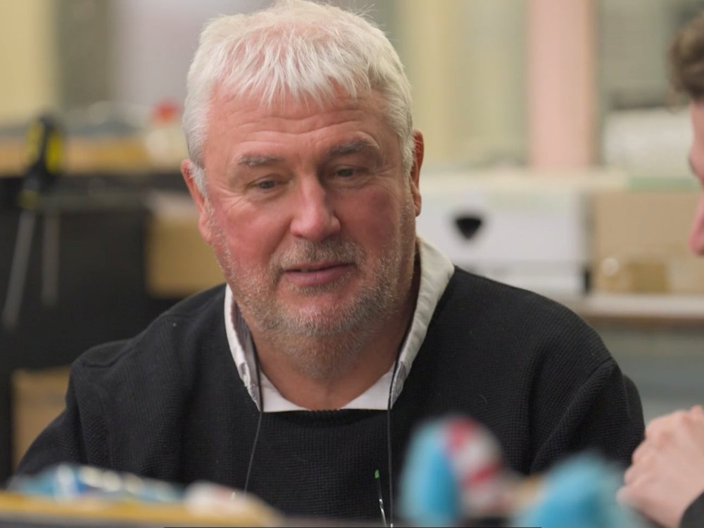 Two men sat down, having a conversation