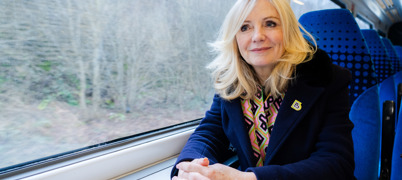 Mayor Tracy Brabin sat at a table on a train by a window looking purposefully ahead