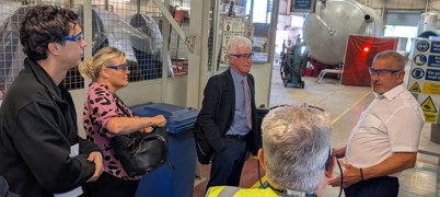 Five people on a factory floor tour