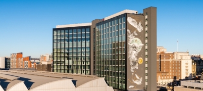 A high-rise building with art on the side