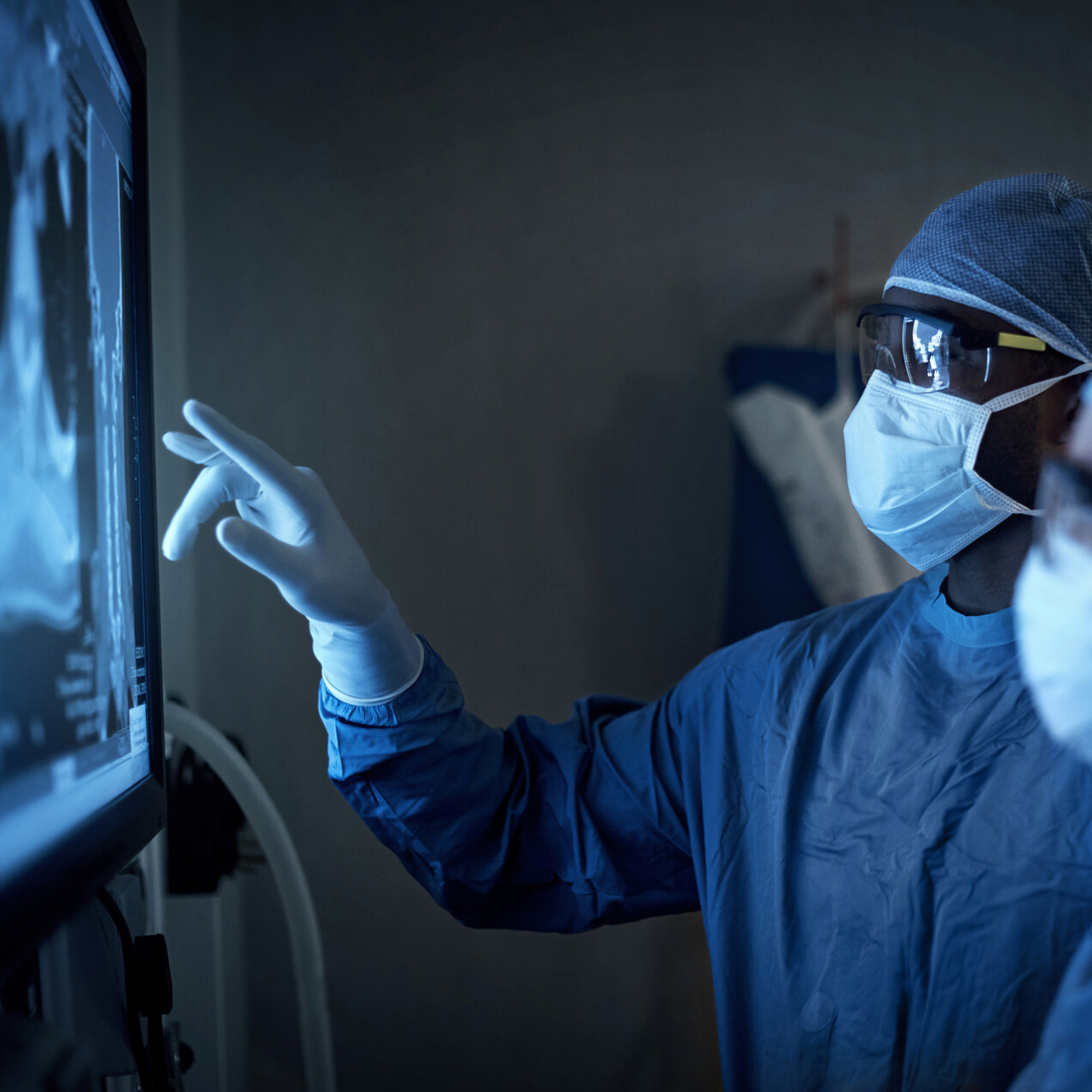 Two Surgeons Examining Medical Scans On a Screen