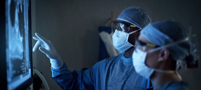 Two Surgeons Examining Medical Scans On a Screen