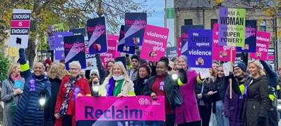 Women at Reclaim the Night march holding banners and placards about violence against women and girls