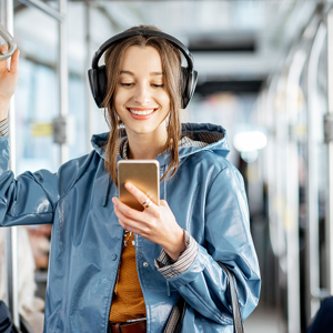 A passenger on a bus looking at her phone