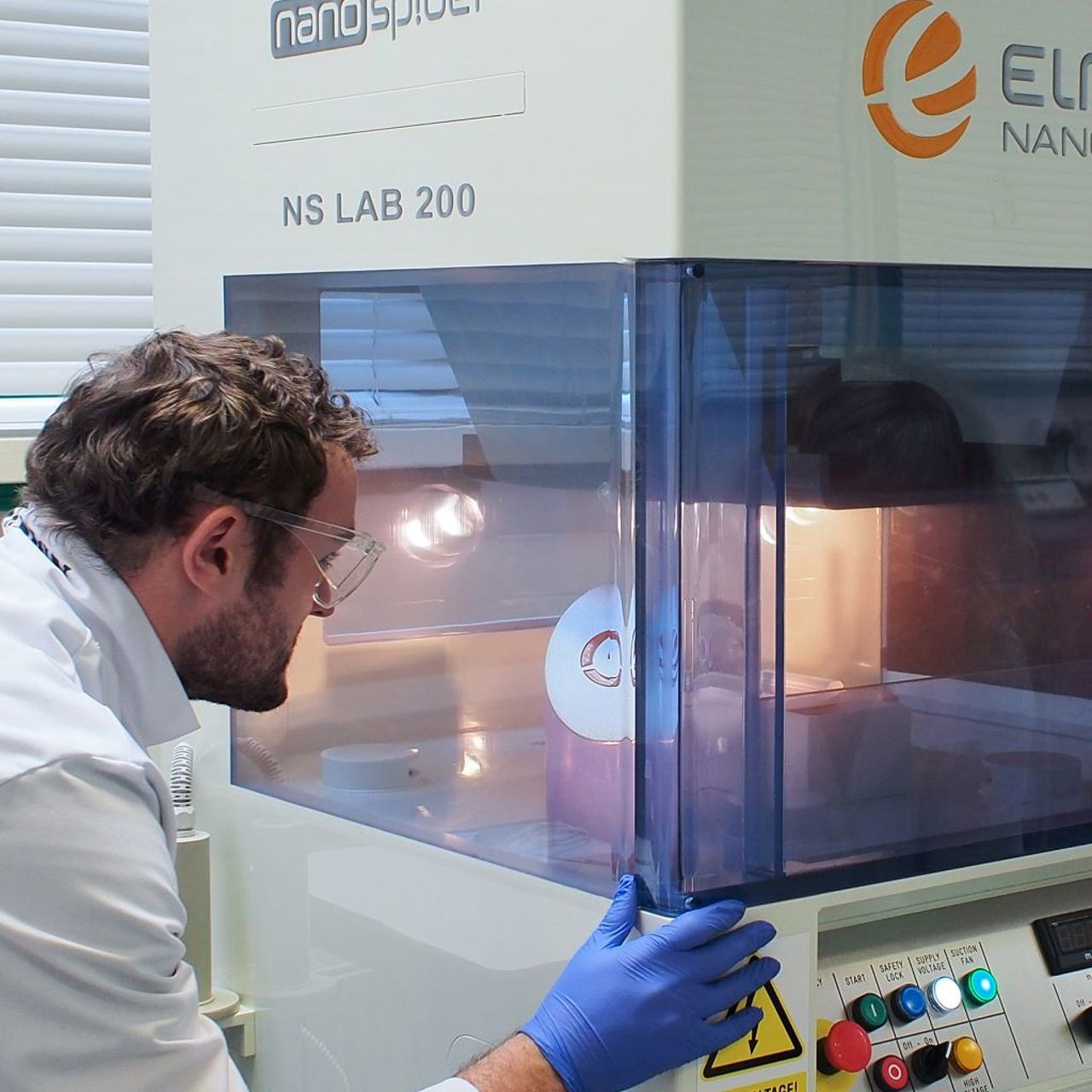 A man working an innovative textiles machine