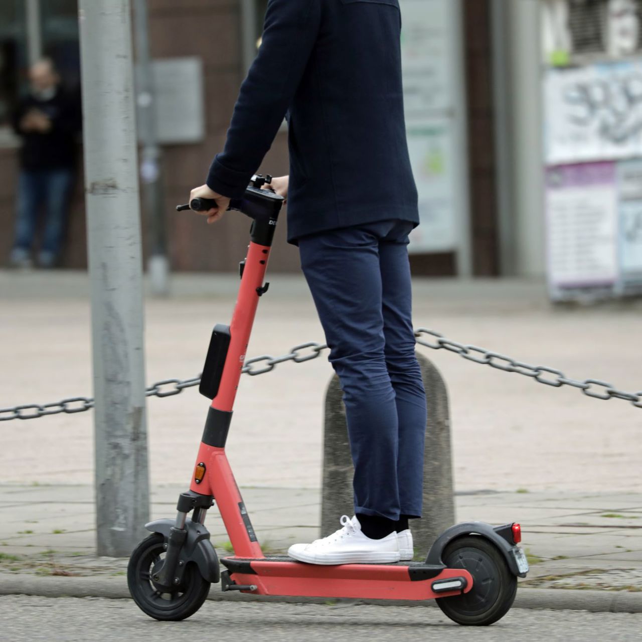 A man riding an e-scooter through the city