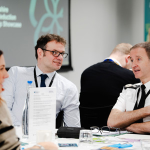 Policing partners talking at an event