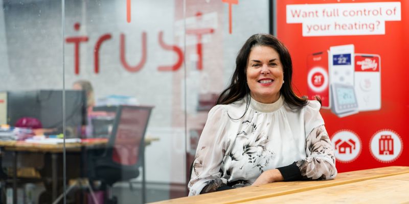 A woman sat in a meeting room, smiling