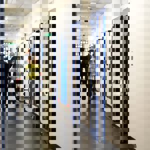 People walking down custody visiting corridor