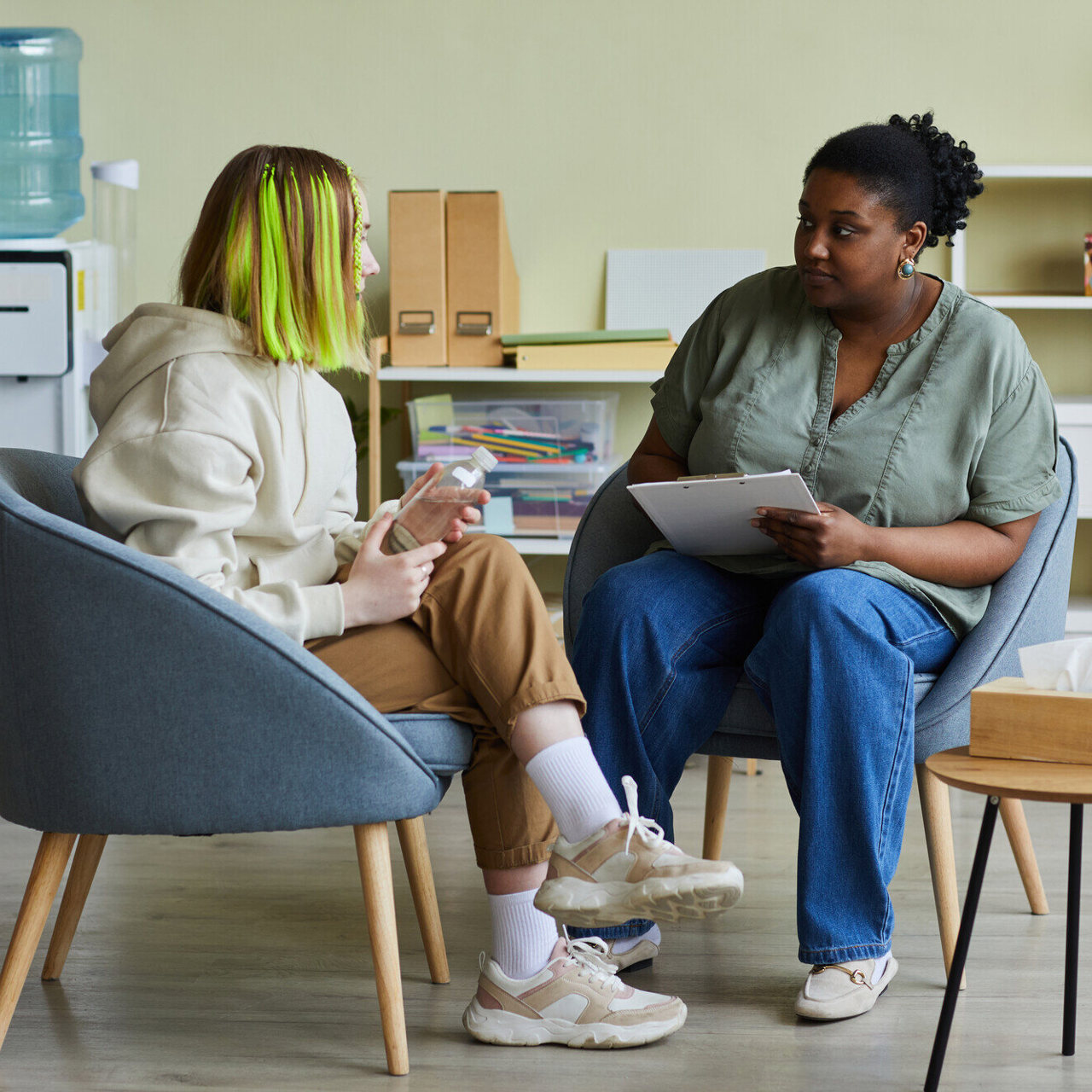 A teenager in conversation with a supportive adult