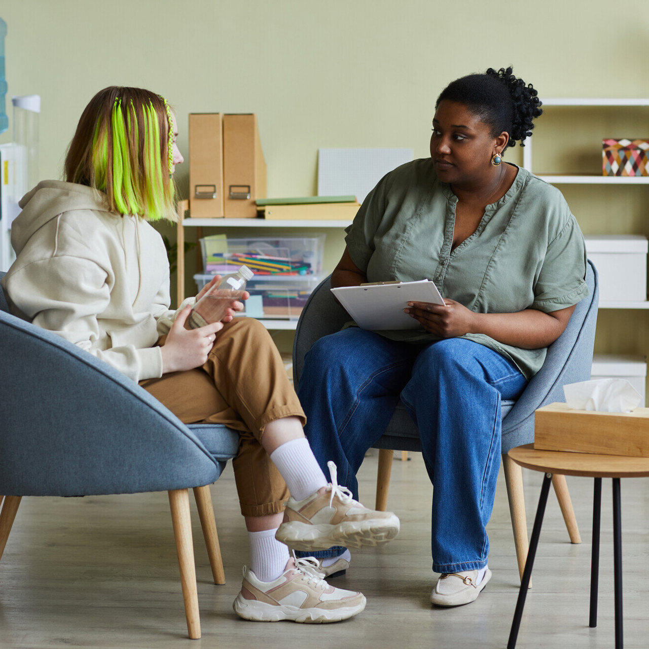 A teenager in conversation with a supportive adult