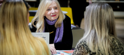 Mayor Tracy Brabin sat listening to two women whose backs of heads are only visible